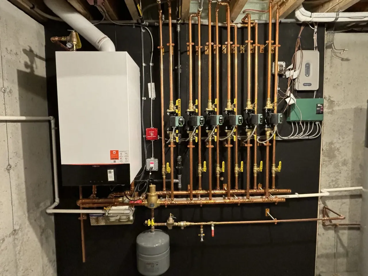 Viessmann boiler with a fully labeled 8-zone copper hydronic manifold and circulators installed by Southern Maine Mechanical