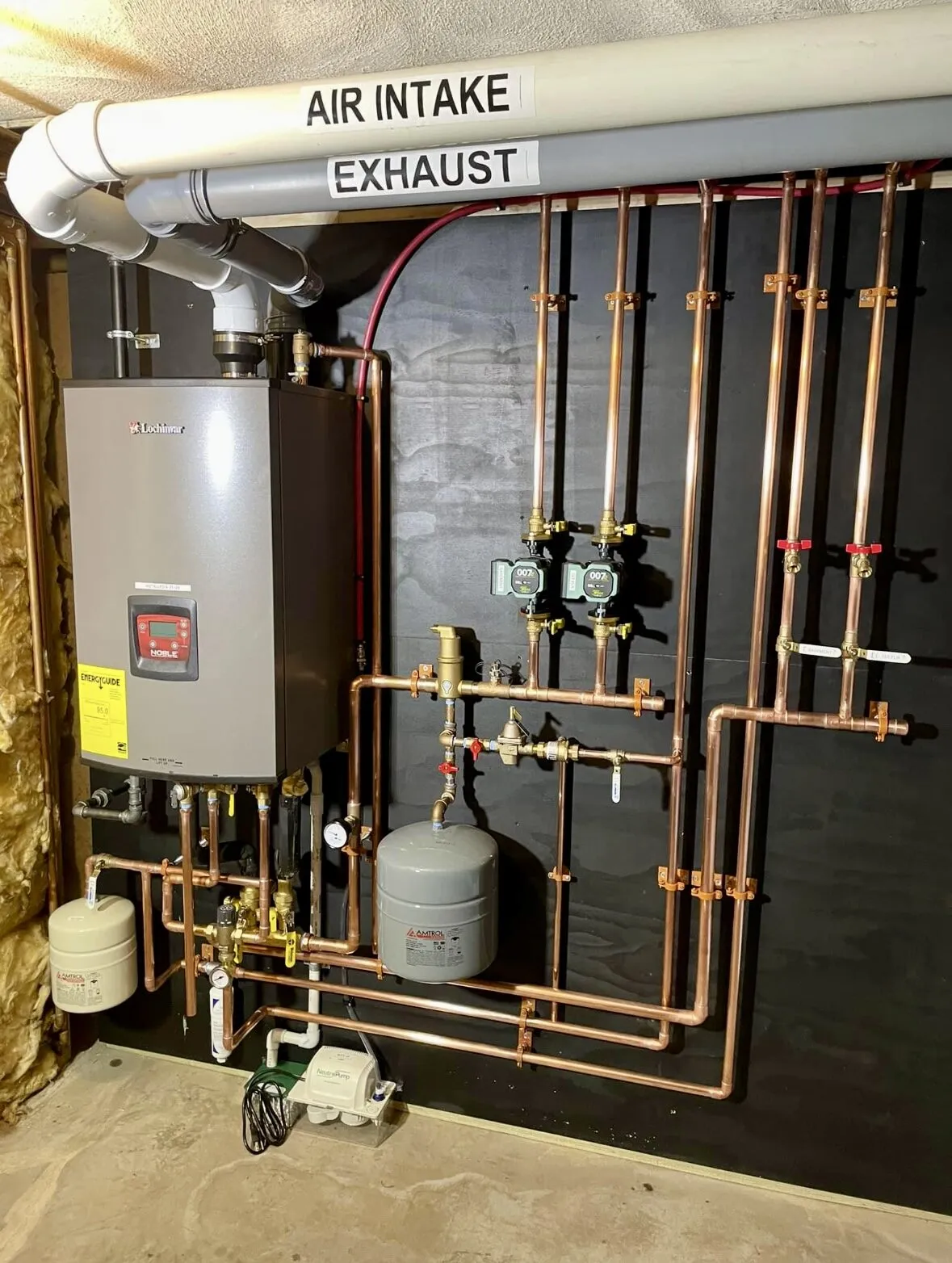 Lochinvar Noble boiler with zone manifold — air intake and exhaust labeled