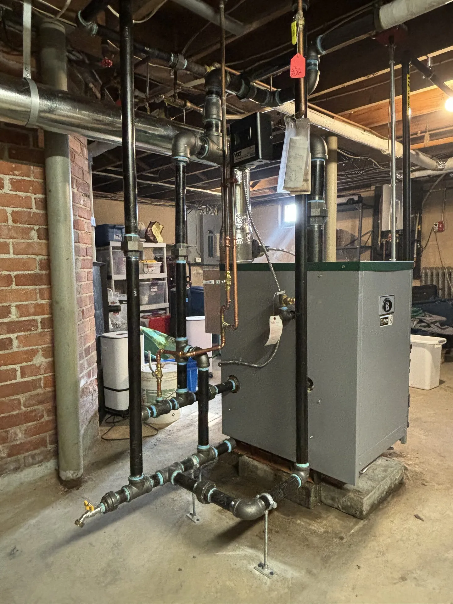 Large commercial boiler installation with black iron steam piping